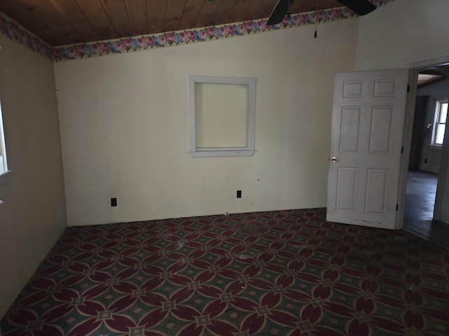 spare room featuring wood ceiling and ceiling fan