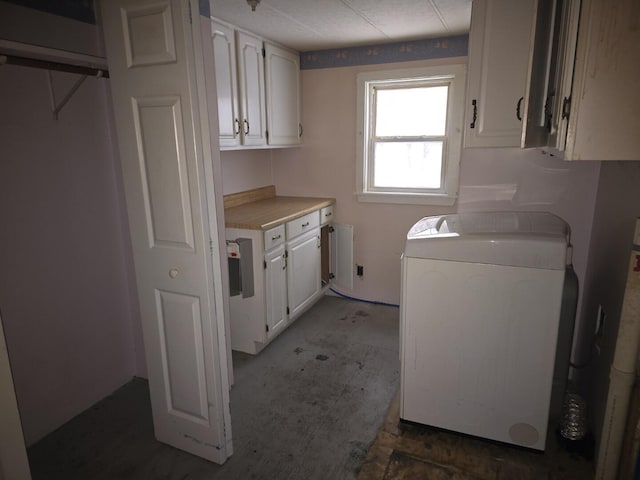 washroom featuring cabinets and separate washer and dryer