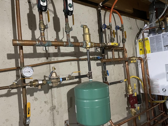 utility room featuring water heater