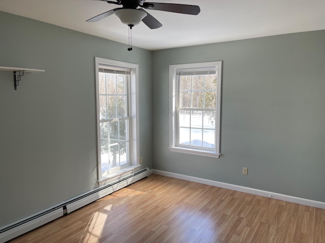 unfurnished room featuring light wood-type flooring, a baseboard radiator, baseboards, and a ceiling fan