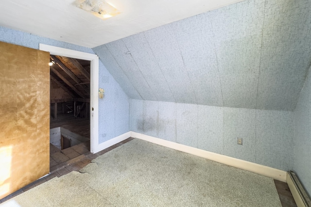 additional living space with lofted ceiling and a baseboard radiator