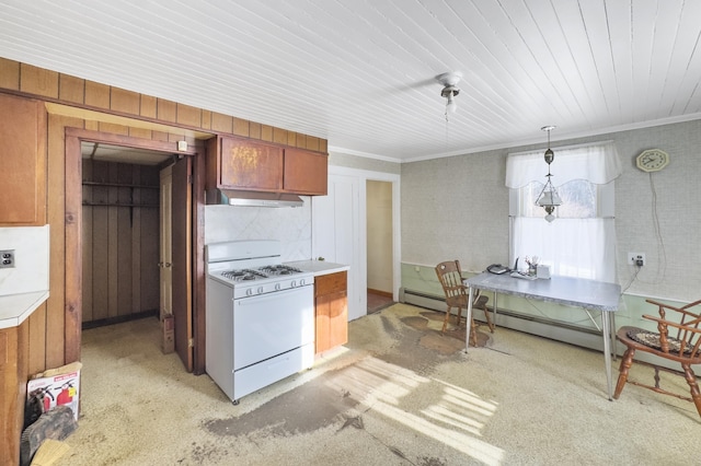 kitchen featuring crown molding, wooden walls, hanging light fixtures, and gas range gas stove