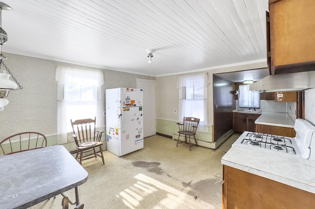 kitchen with ornamental molding, pendant lighting, wooden ceiling, and white appliances