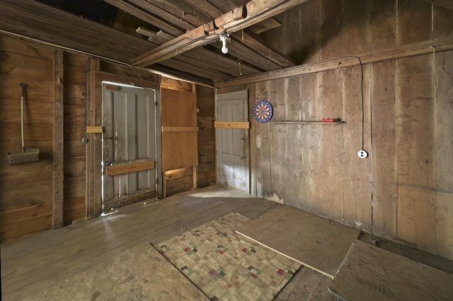 misc room featuring wooden walls