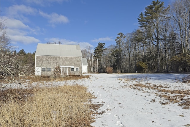 view of snow covered exterior with an outdoor structure