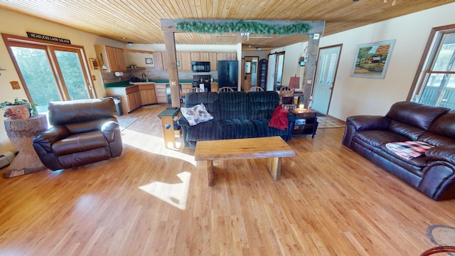 living room featuring wood ceiling and light hardwood / wood-style floors