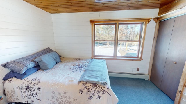 bedroom featuring carpet floors, a baseboard radiator, wooden ceiling, and a closet