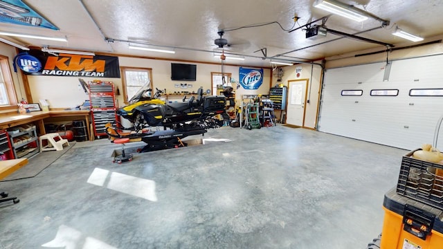 garage with a garage door opener and a workshop area