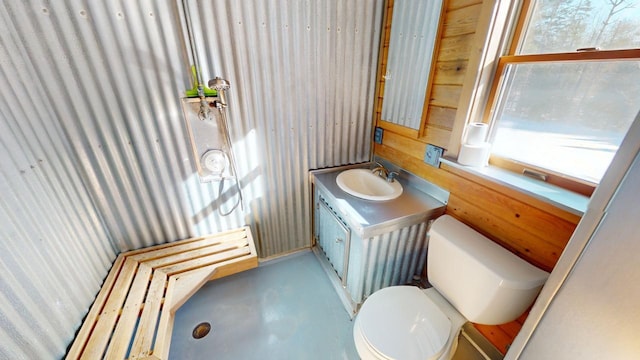 bathroom with vanity, concrete floors, and toilet