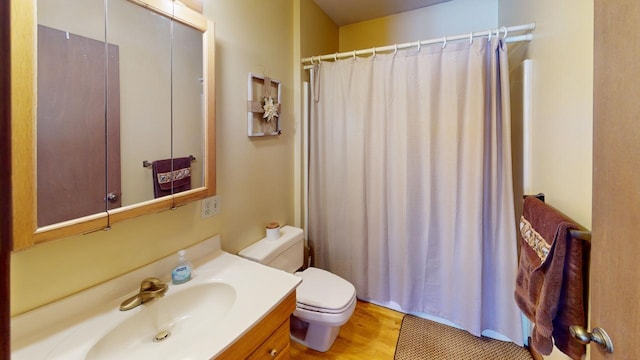 bathroom with vanity, hardwood / wood-style floors, toilet, and a shower with shower curtain