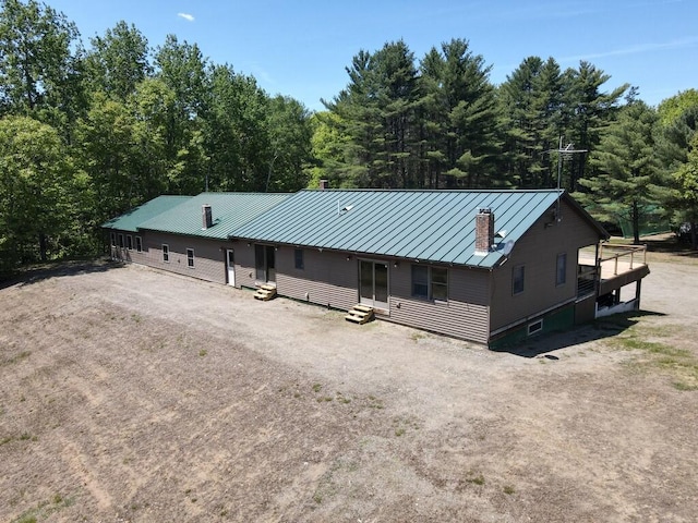 1449 Main Rd, Greenbush, ME 04418 - view of front facade featuring entry steps, a standing seam roof, a chimney, and metal roof