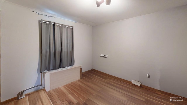 unfurnished room with hardwood / wood-style flooring