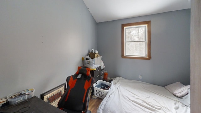 bedroom with hardwood / wood-style flooring