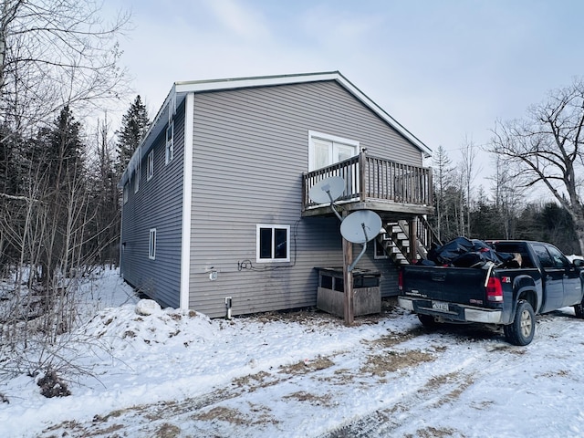 view of snowy exterior featuring a deck