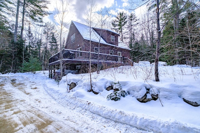 view of snowy exterior with a deck