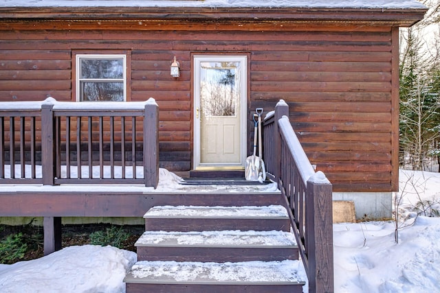 view of snow covered property entrance