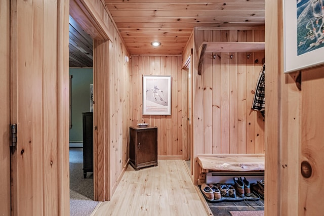 mudroom with wooden ceiling, wooden walls, light hardwood / wood-style flooring, and a baseboard heating unit