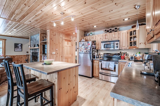 kitchen with a breakfast bar, light brown cabinets, wooden ceiling, appliances with stainless steel finishes, and pendant lighting