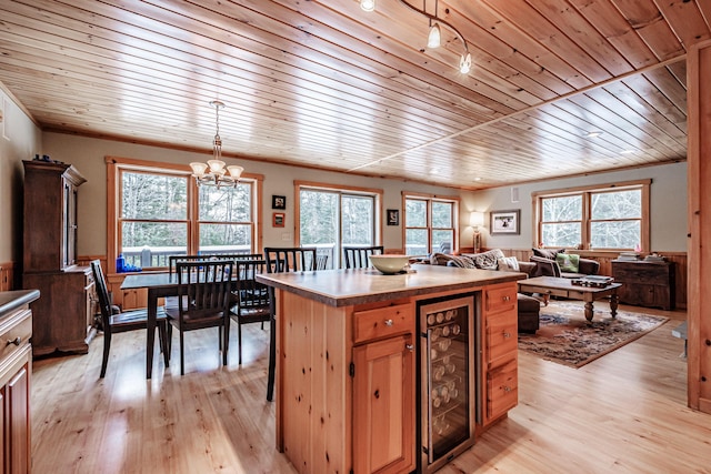 kitchen with an inviting chandelier, decorative light fixtures, wooden ceiling, beverage cooler, and light hardwood / wood-style floors