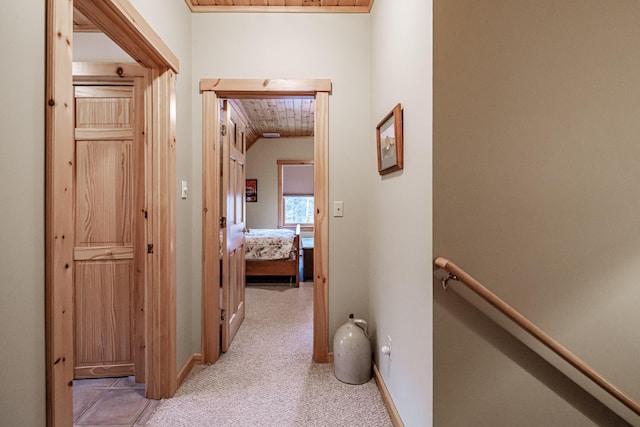 hall with light colored carpet and wooden ceiling