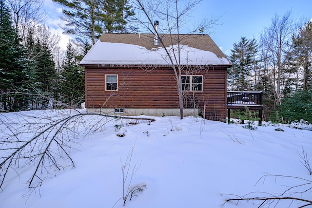 view of snowy exterior featuring a deck