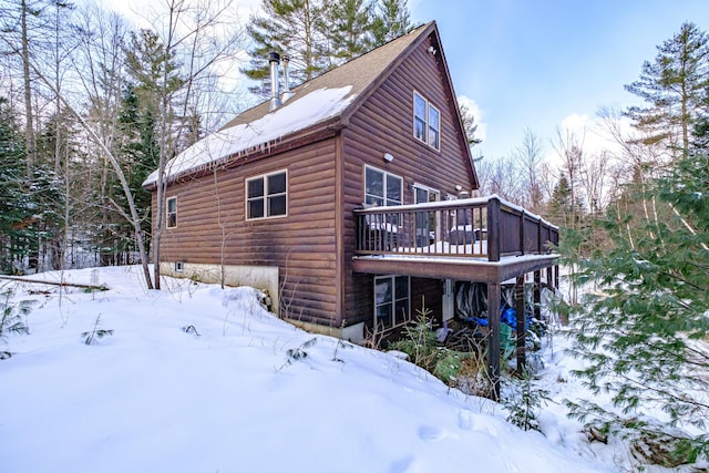 view of snow covered exterior featuring a wooden deck