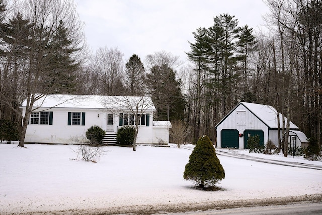 view of front of house with a garage and an outdoor structure