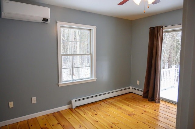 empty room with a baseboard radiator, ceiling fan, a wall unit AC, and light hardwood / wood-style flooring