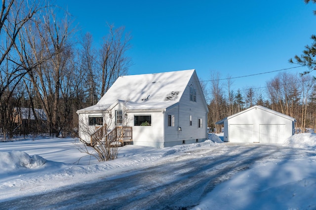 view of snow covered exterior with a garage and an outdoor structure