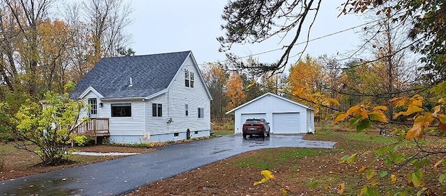 view of home's exterior with a garage and an outdoor structure