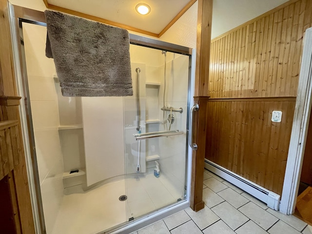 bathroom featuring a baseboard radiator, tile patterned floors, wooden walls, and a shower with shower door