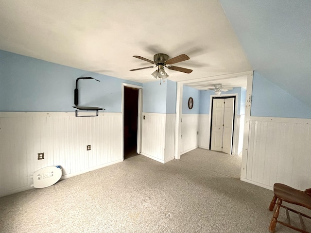 additional living space featuring lofted ceiling, ceiling fan, and carpet