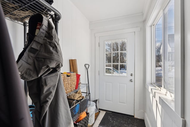 doorway featuring ornamental molding and tile patterned floors