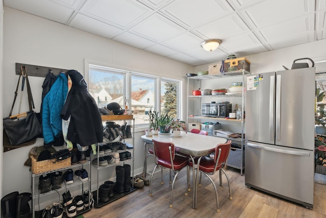 kitchen with light hardwood / wood-style flooring and appliances with stainless steel finishes