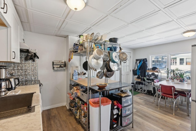 kitchen with white cabinetry and hardwood / wood-style floors