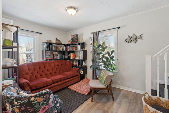 living room with a wealth of natural light, wood-type flooring, and ornamental molding