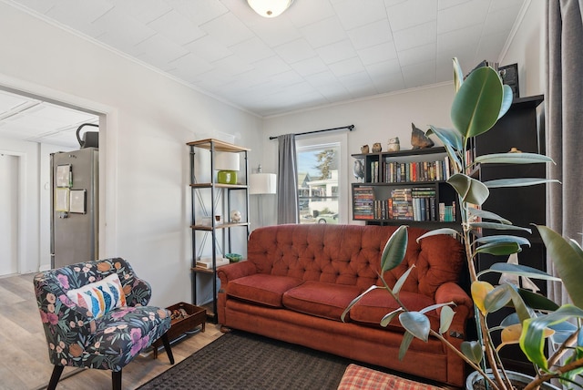 living room featuring hardwood / wood-style flooring and ornamental molding