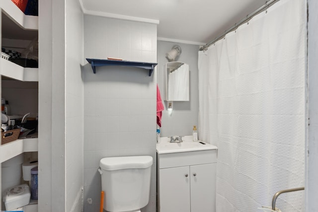 bathroom featuring vanity, crown molding, and toilet