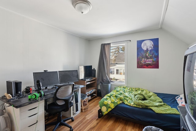 bedroom featuring hardwood / wood-style floors and vaulted ceiling