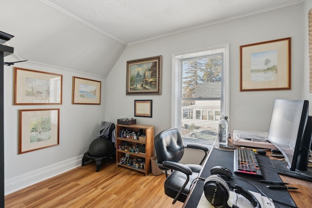 office space with crown molding, lofted ceiling, and light hardwood / wood-style flooring