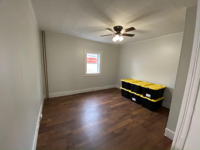 empty room featuring ceiling fan and dark hardwood / wood-style floors