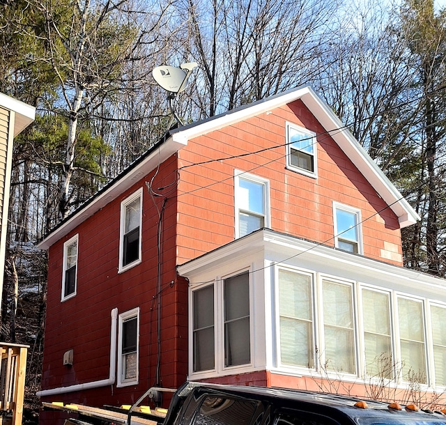 view of side of property featuring a sunroom