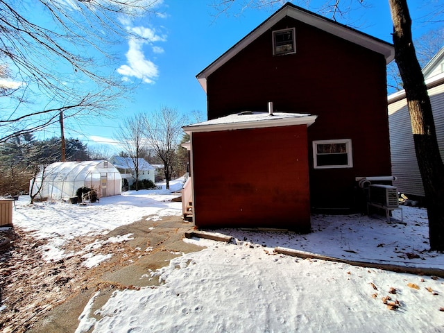 view of snow covered exterior with an outdoor structure