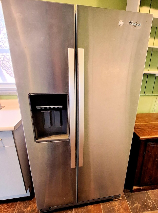 room details featuring stainless steel fridge with ice dispenser