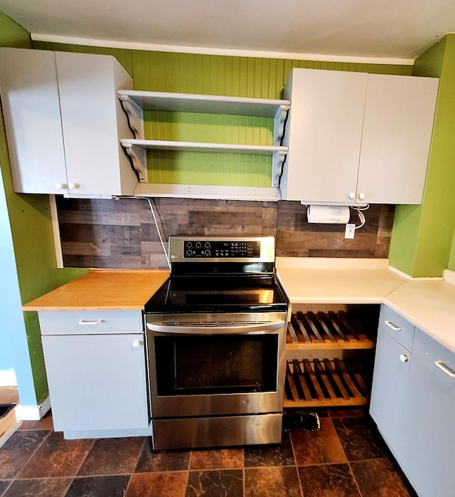 kitchen with electric stove and white cabinets