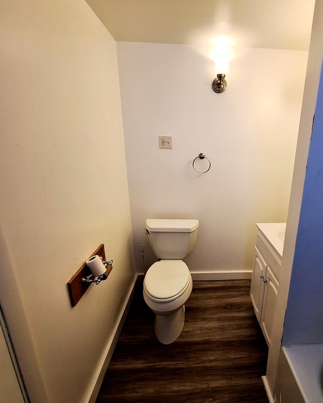 bathroom with vanity, hardwood / wood-style flooring, and toilet