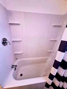 bathroom with shower / bathtub combination with curtain