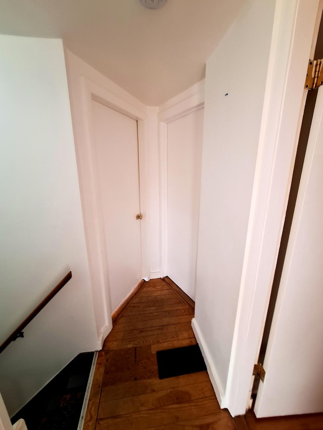 stairway with hardwood / wood-style floors