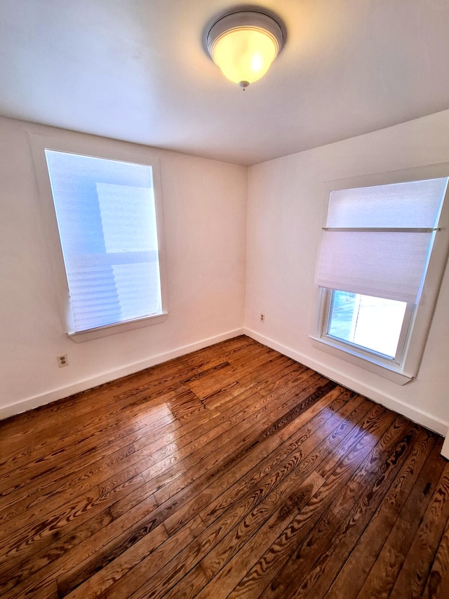 unfurnished room featuring dark hardwood / wood-style flooring