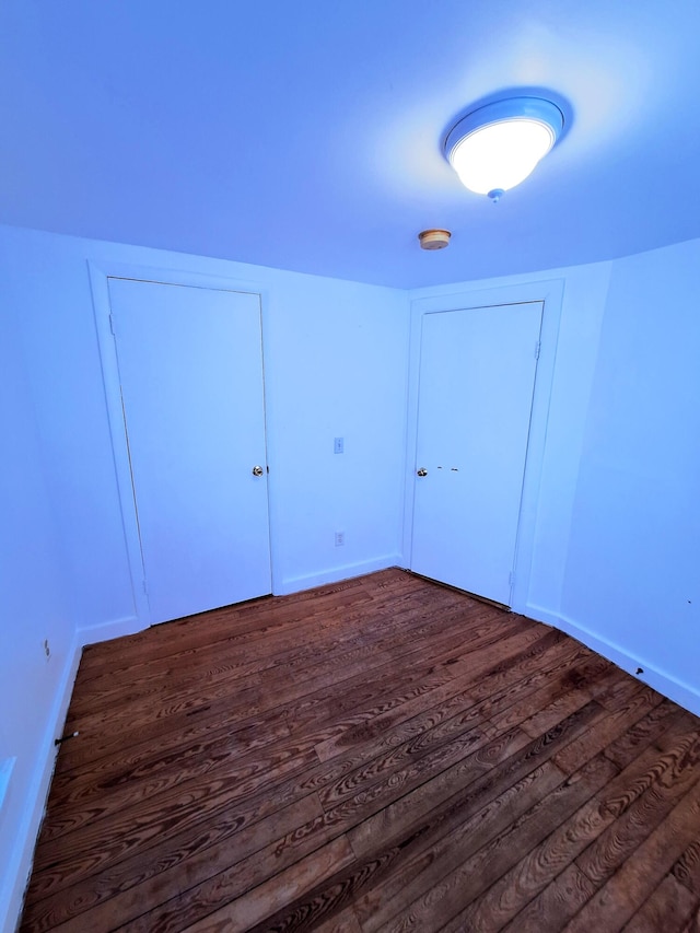 bonus room with dark hardwood / wood-style floors